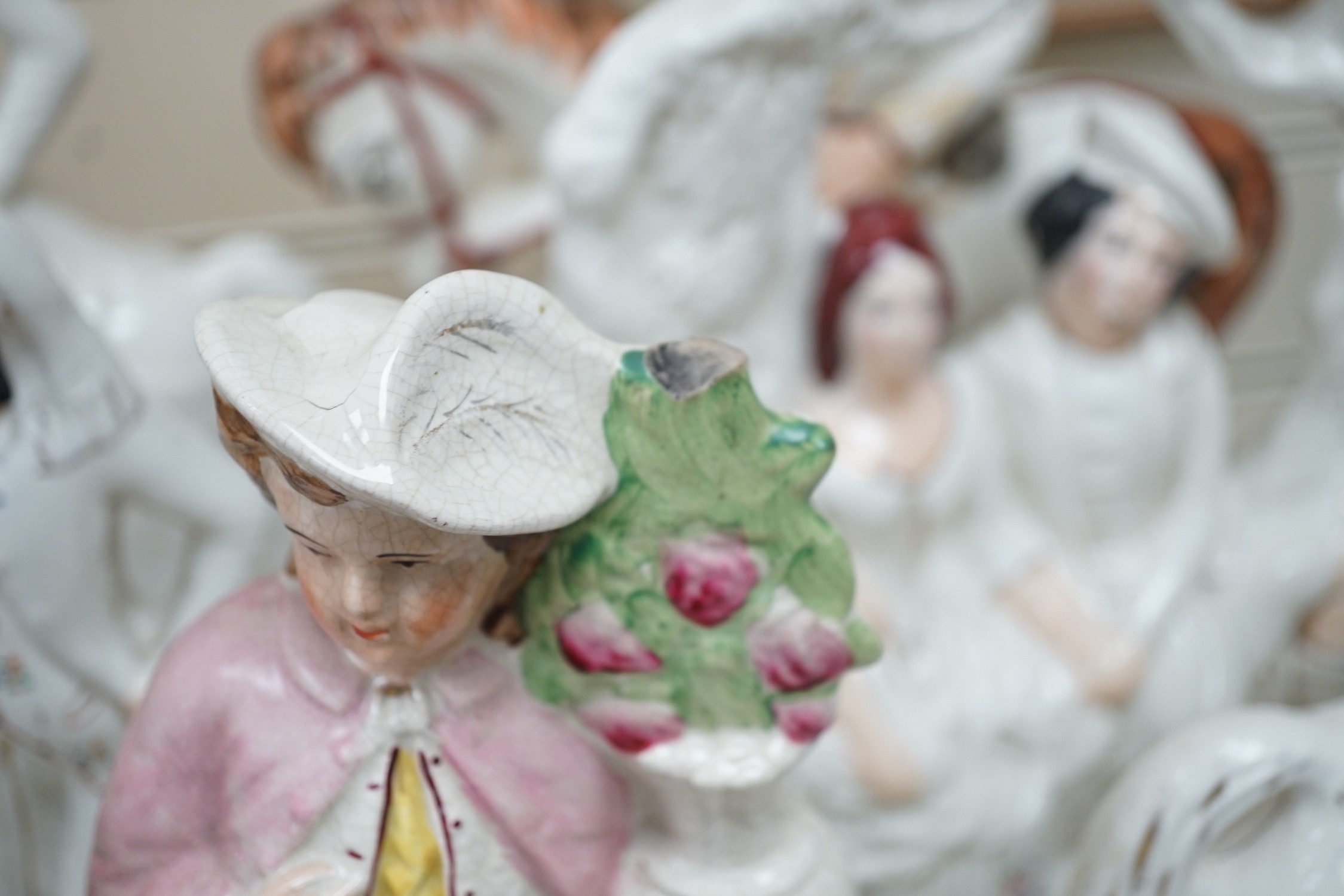 A collection of Victorian Staffordshire pottery flat-back figures and groups, tallest 36cm